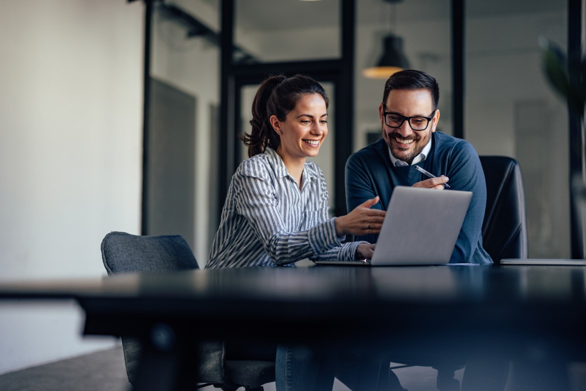 Portrait of two business colleagues, looking at something online